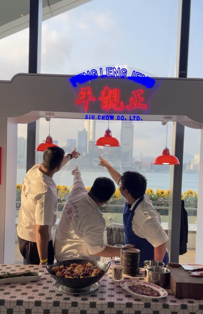Peng Leng Jeng staff at an outdoor pop-up with city skyline
