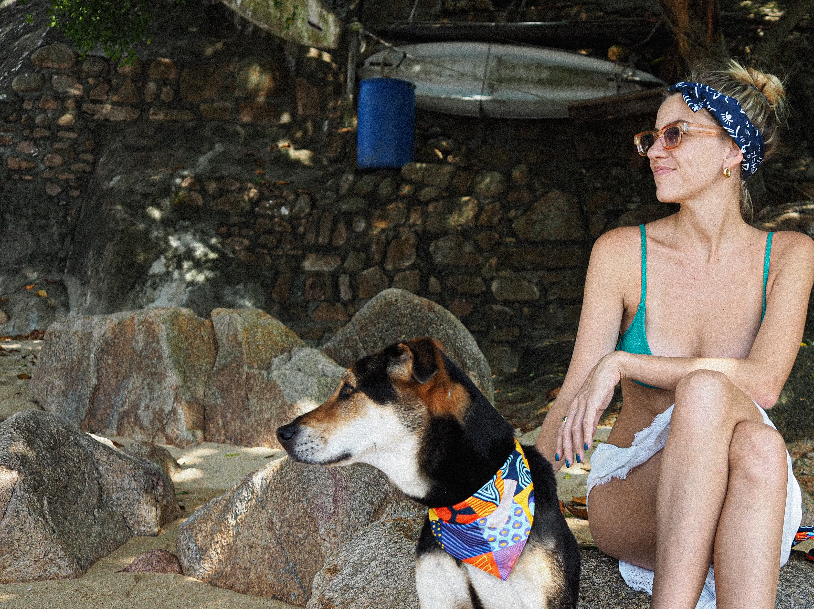 Woman and dog by the water wearing colourful Scruff bandanas